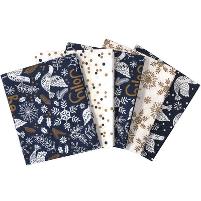 A fat quarter bundle of 5 navy and cream christmas cotton fabrics with doves, spots and snowflakes