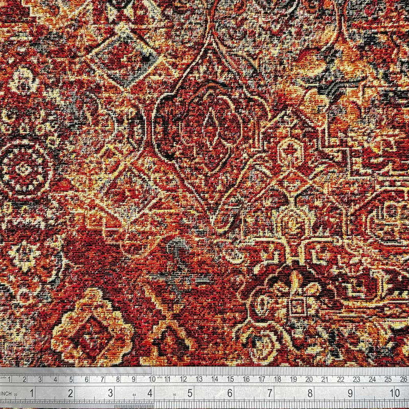 A baroque design printed on tapestry upholstery fabric with a cm ruler
