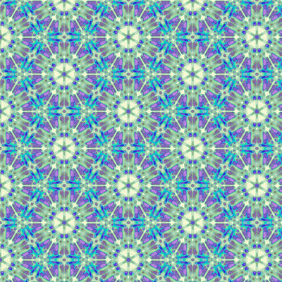 A geometric pattern in purples and greens printed on a cotton quilting fabric
