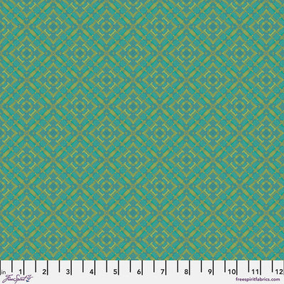 Teal fabric with a geometric pattern and a ruler at the bottom.