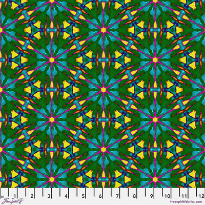 A brightly coloured geometric pattern printed on cotton quilting fabric with a cm ruler