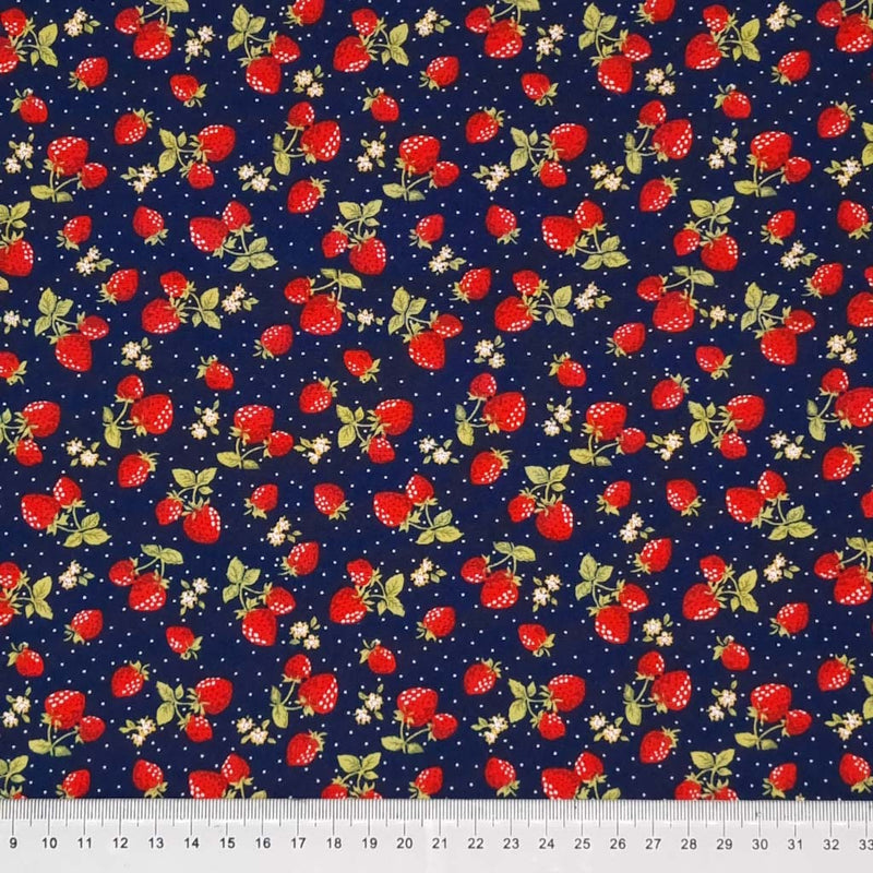 Ditsy red strawberries printed on a navy cotton poplin fabric with a cm ruler