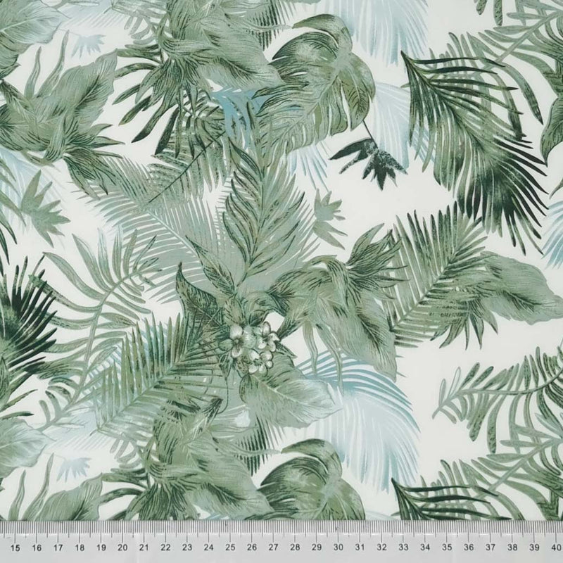 Forest green leaves are printed on an ivory cotton poplin by Rose & Hubble with a cm ruler