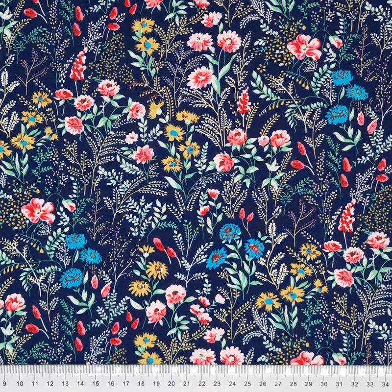 A garden of beautiful flowers printed on a navy cotton poplin fabric with a cm ruler