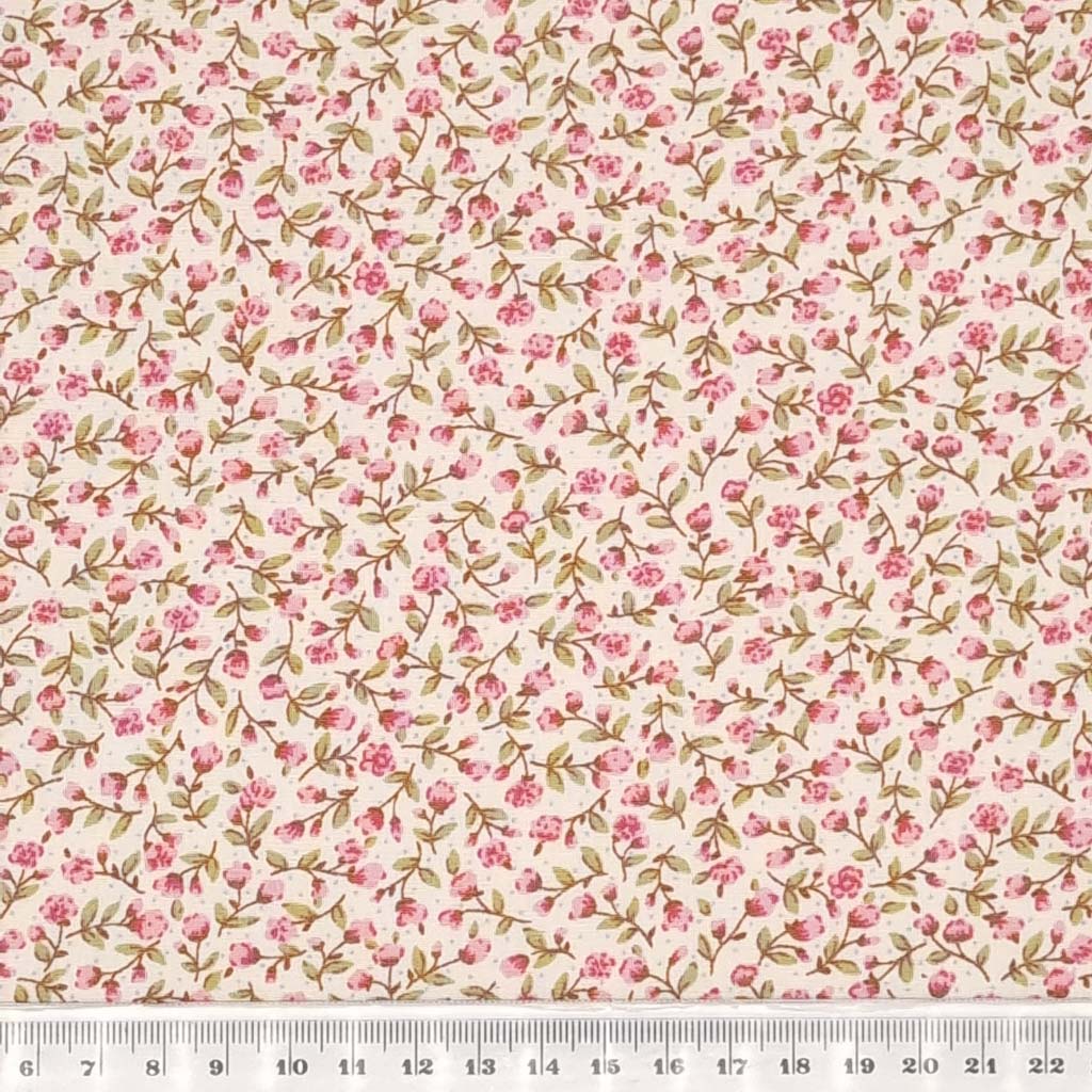 A tiny pink flower design printed on a cotton poplin fabric by Rose & Hubble