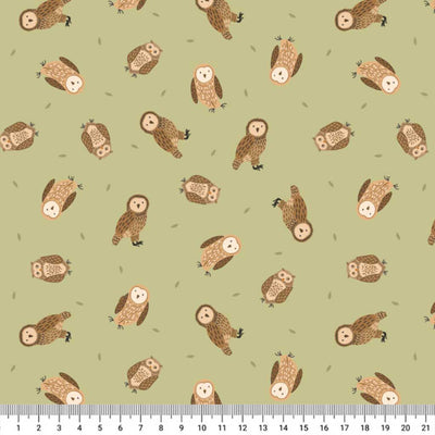 Pattern of small owls on a light green cotton quilting fabric with a ruler at the bottom.