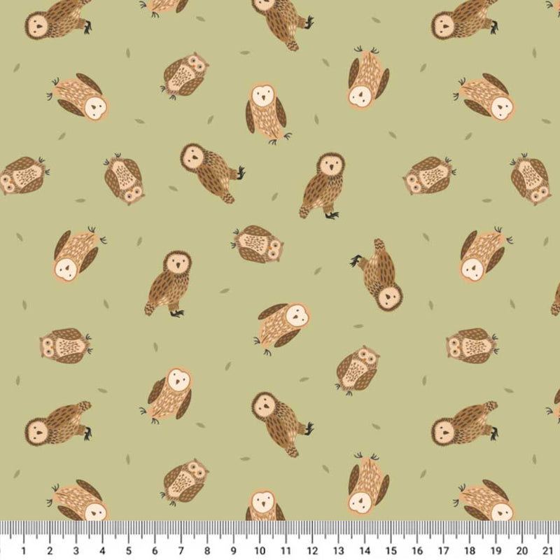 Pattern of small owls on a light green cotton quilting fabric with a ruler at the bottom.