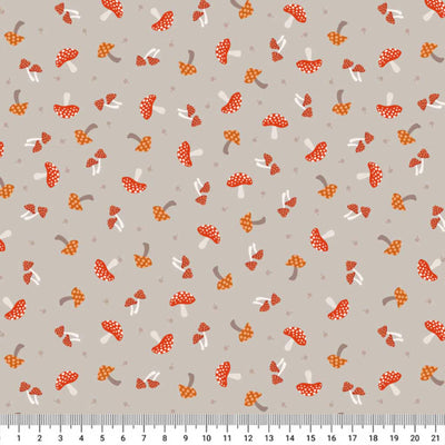 Pattern of red and orange mushrooms on a gray cotton quilting fabric with a ruler at the bottom.