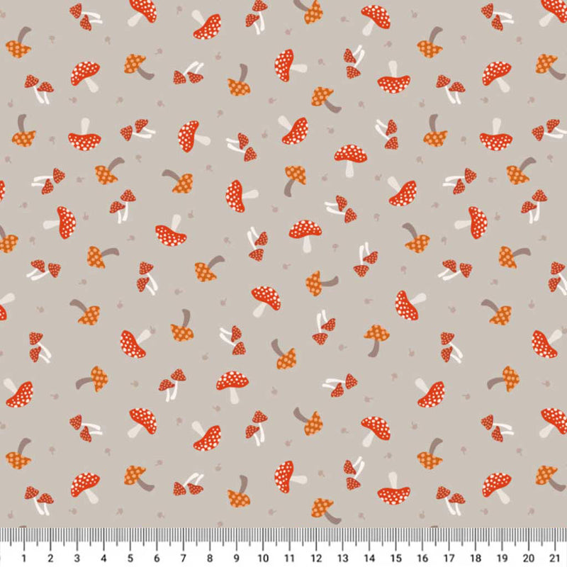 Pattern of red and orange mushrooms on a gray cotton quilting fabric with a ruler at the bottom.