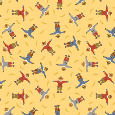 Pattern of scarecrows and wheat on a yellow cotton quilting fabric