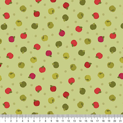 Pattern of red and green apples on a light green cotton quilting fabric with a ruler at the bottom.