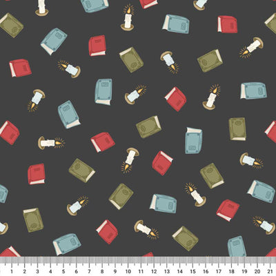Pattern of books and candles on a dark cotton quilting fabric with a ruler at the bottom.