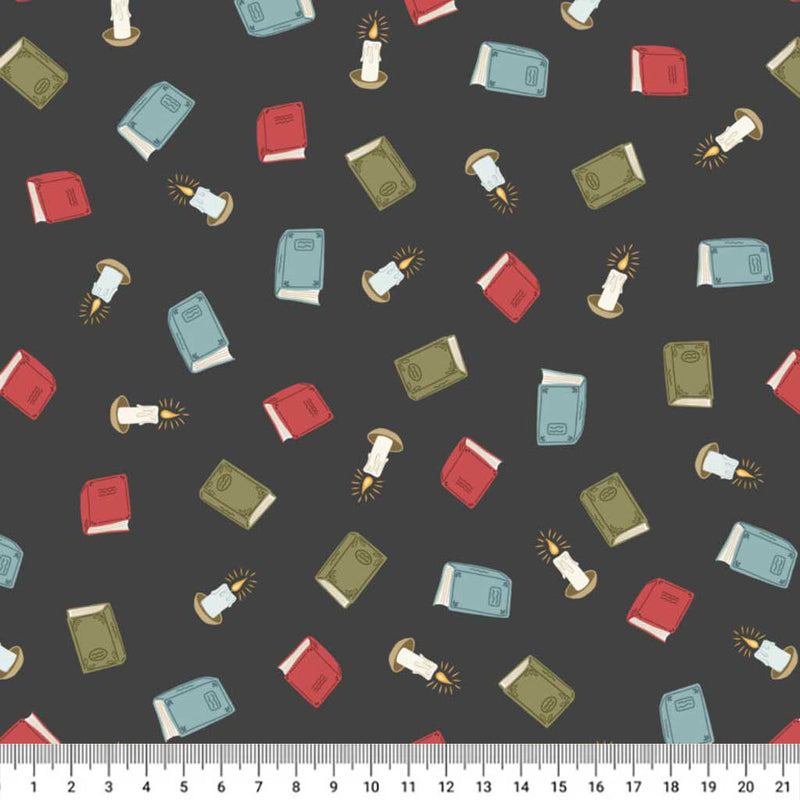 Pattern of books and candles on a dark cotton quilting fabric with a ruler at the bottom.