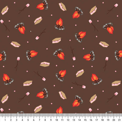 Pattern of campfire, marshmallows, and leaves on a brown cotton quilting fabric with a ruler at the bottom.