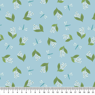 Dainty dragonflies fluttering around intricate lilies, on a blue 100% cotton fabric with a cm ruler