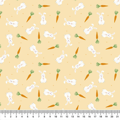 Springtime bunnies and carrots scattered among a pastel orange 100% cotton fabric with a cm ruler