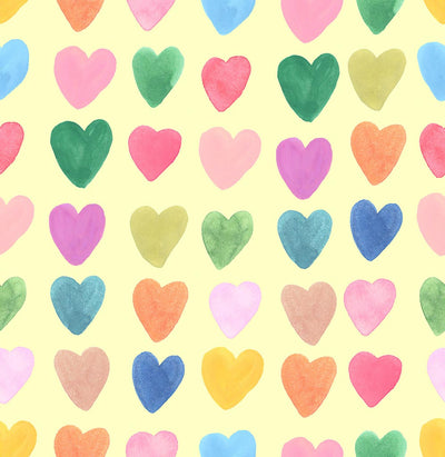 Large colourful hearts printed on a yellow cotton quilting fabric by Lewis & Irene