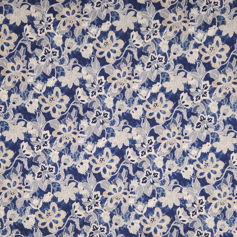 Floral pattern with white flowers on a blue pima cotton lawn fabric