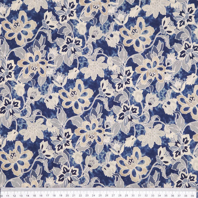 Floral pattern fabric with blue and white flowers on a blue pima cotton lawn fabric with a cm ruler