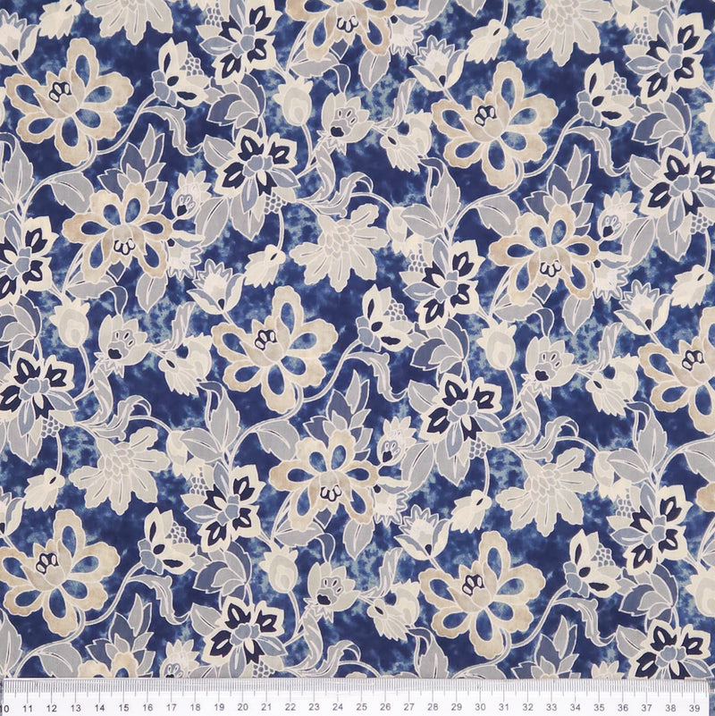 Floral pattern fabric with blue and white flowers on a blue pima cotton lawn fabric with a cm ruler