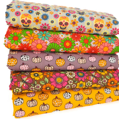Stack of colourful fat quarters with floral and pumpkin patterns