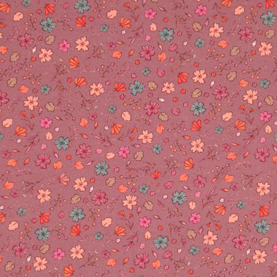 A ditsy floral pattern printed on a dusky pink cotton jersey fabric