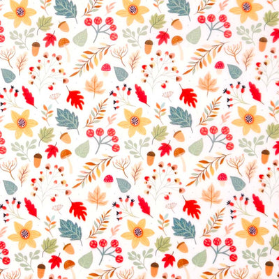 Pattern of autumn leaves, flowers, and berries on a white polycotton fabric