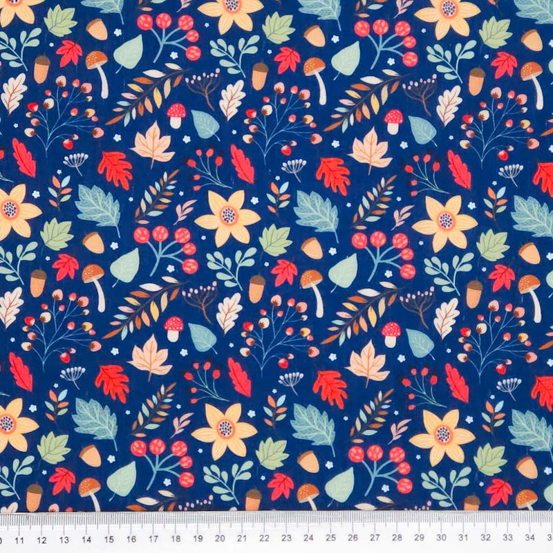 Colorful floral and leaf pattern on a blue polycotton fabric with a ruler at the bottom.