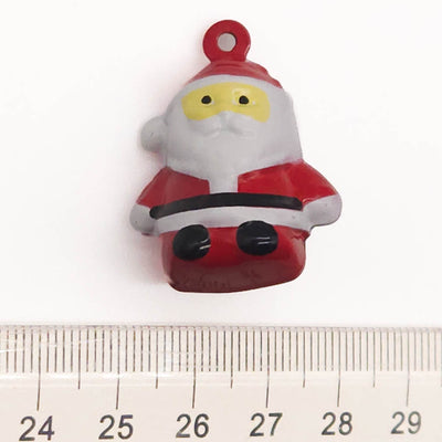 Small Santa Claus bell with a red hat and black boots on a white background, measured against a ruler.