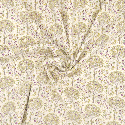 Fabric with a tree pattern on a cream pima cotton lawn fabric