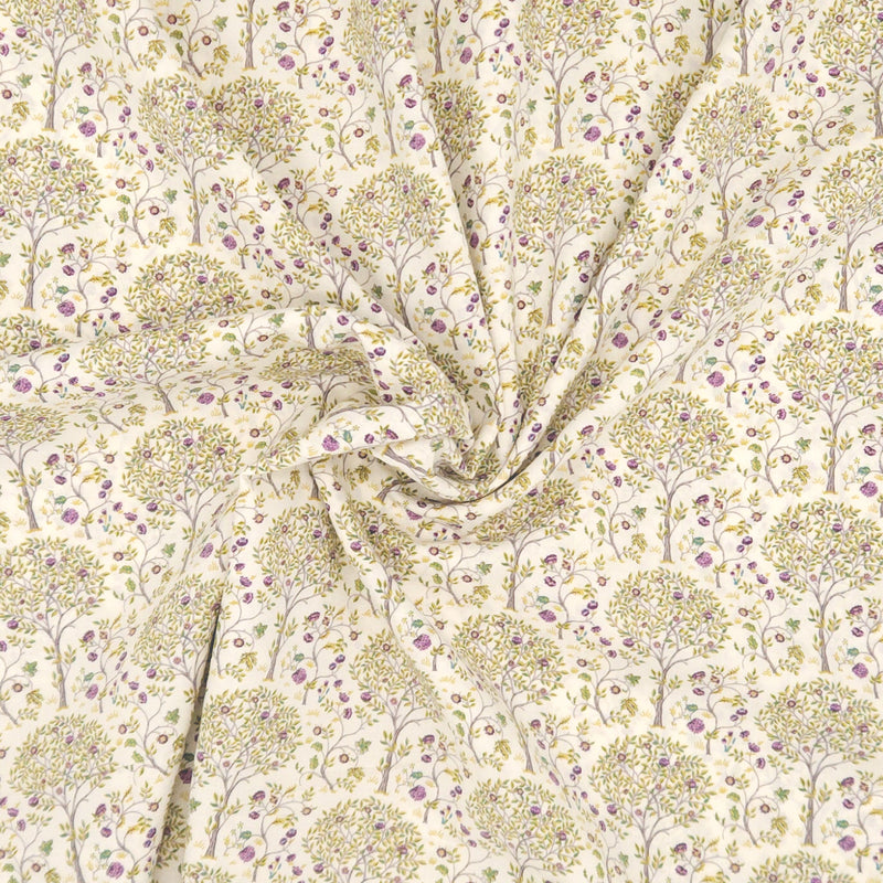 Fabric with a tree pattern on a cream pima cotton lawn fabric
