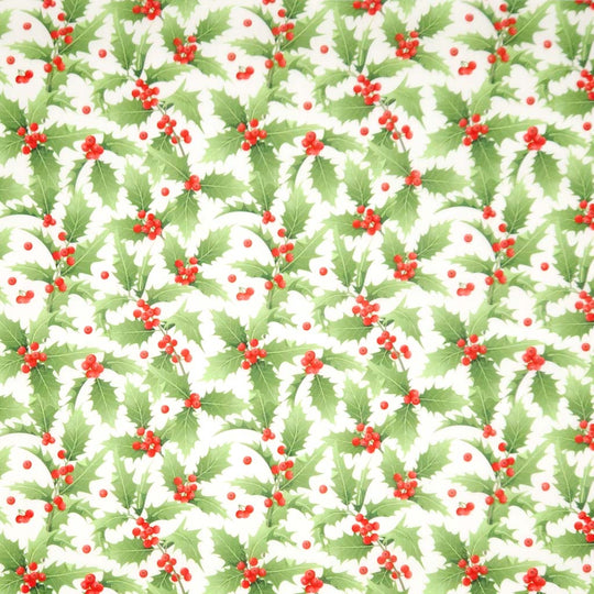 Pattern of green holly leaves and red berries on a white background