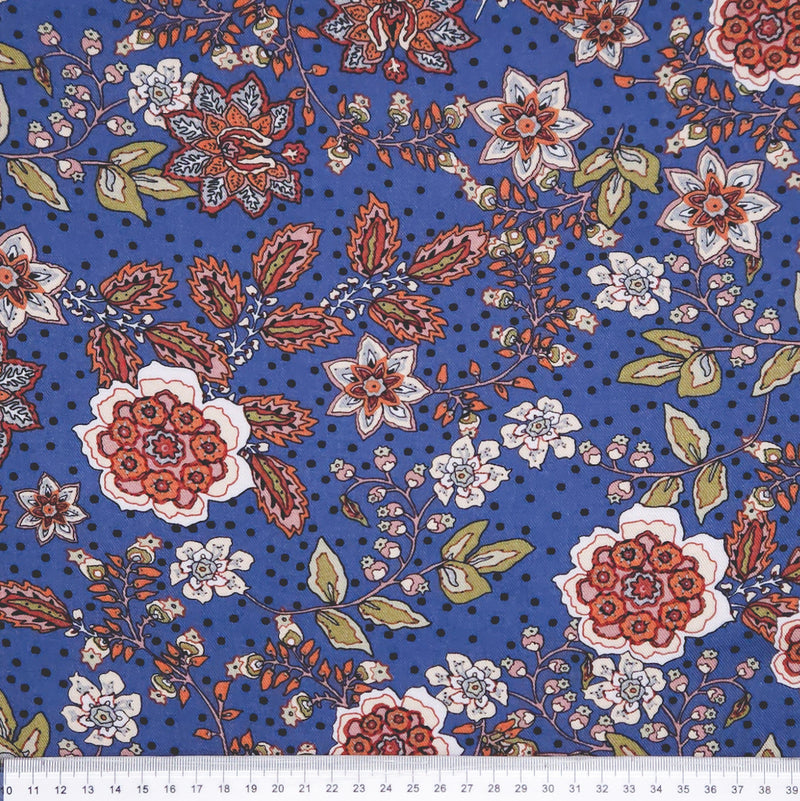 Floral pattern with red, white, and green flowers on a blue viscose fabric with a cm ruler