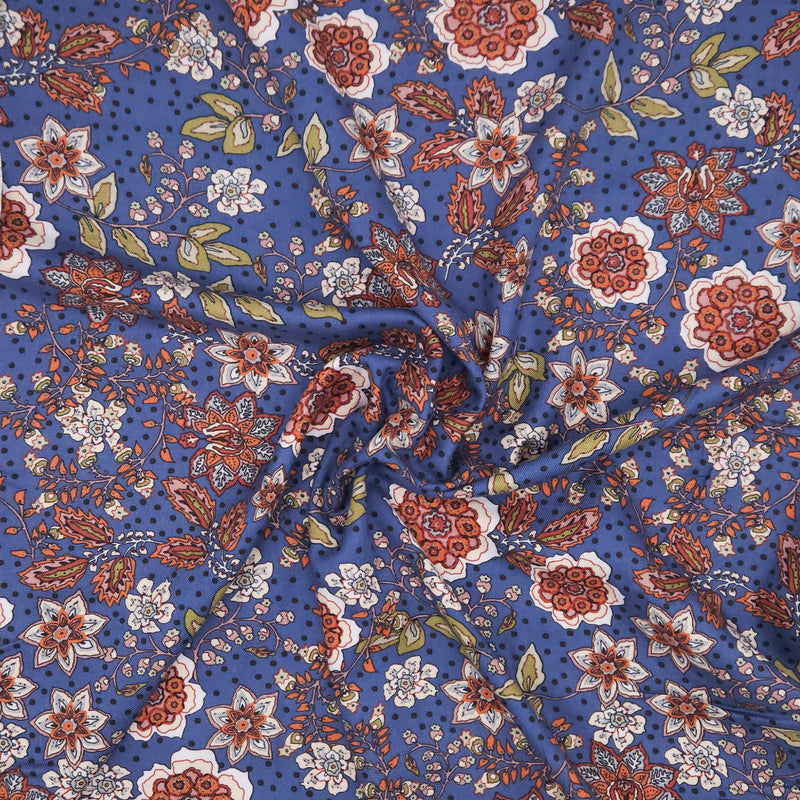 Floral pattern with red, white, and green flowers on a blue viscose fabric