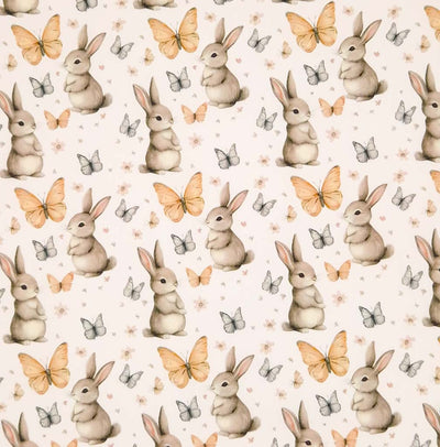 Bunny rabbits and butterflies printed on an ivory cotton poplin fabric