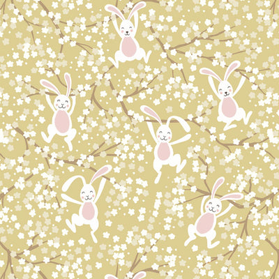 Easter bunnies and spring blossom printed on a yellow cotton fabric