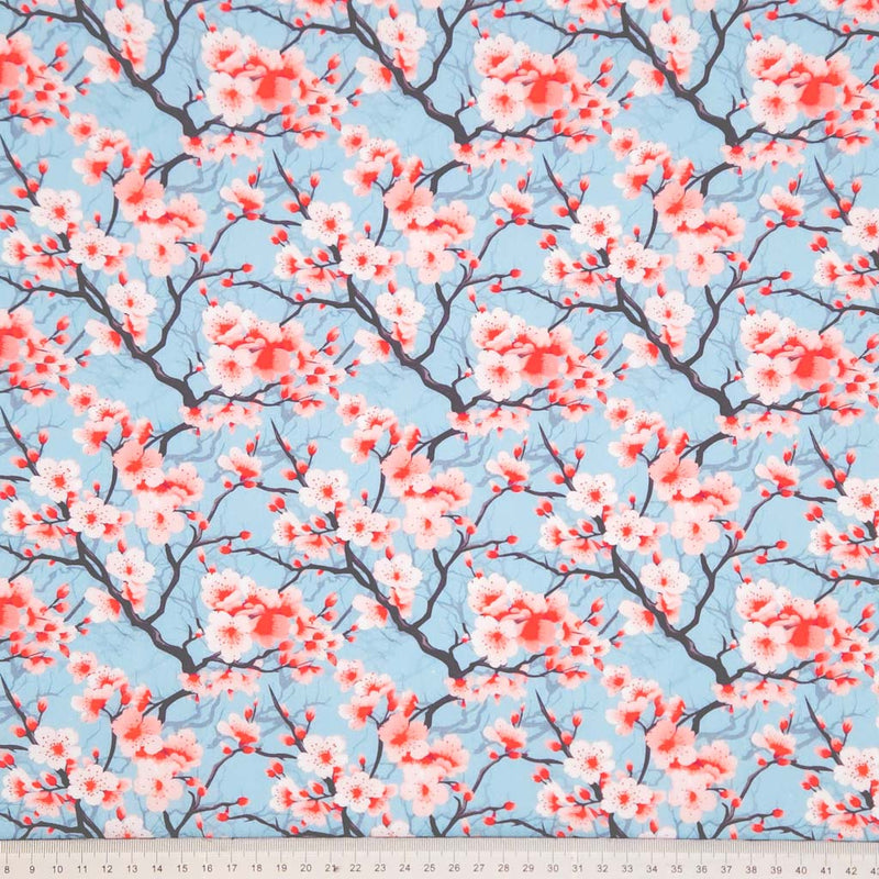Cherry blossom pattern on a blue background with a cm ruler