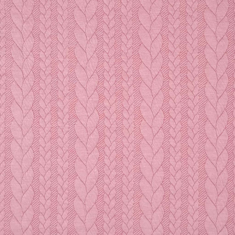 A rose pink coloured cable knit fabric