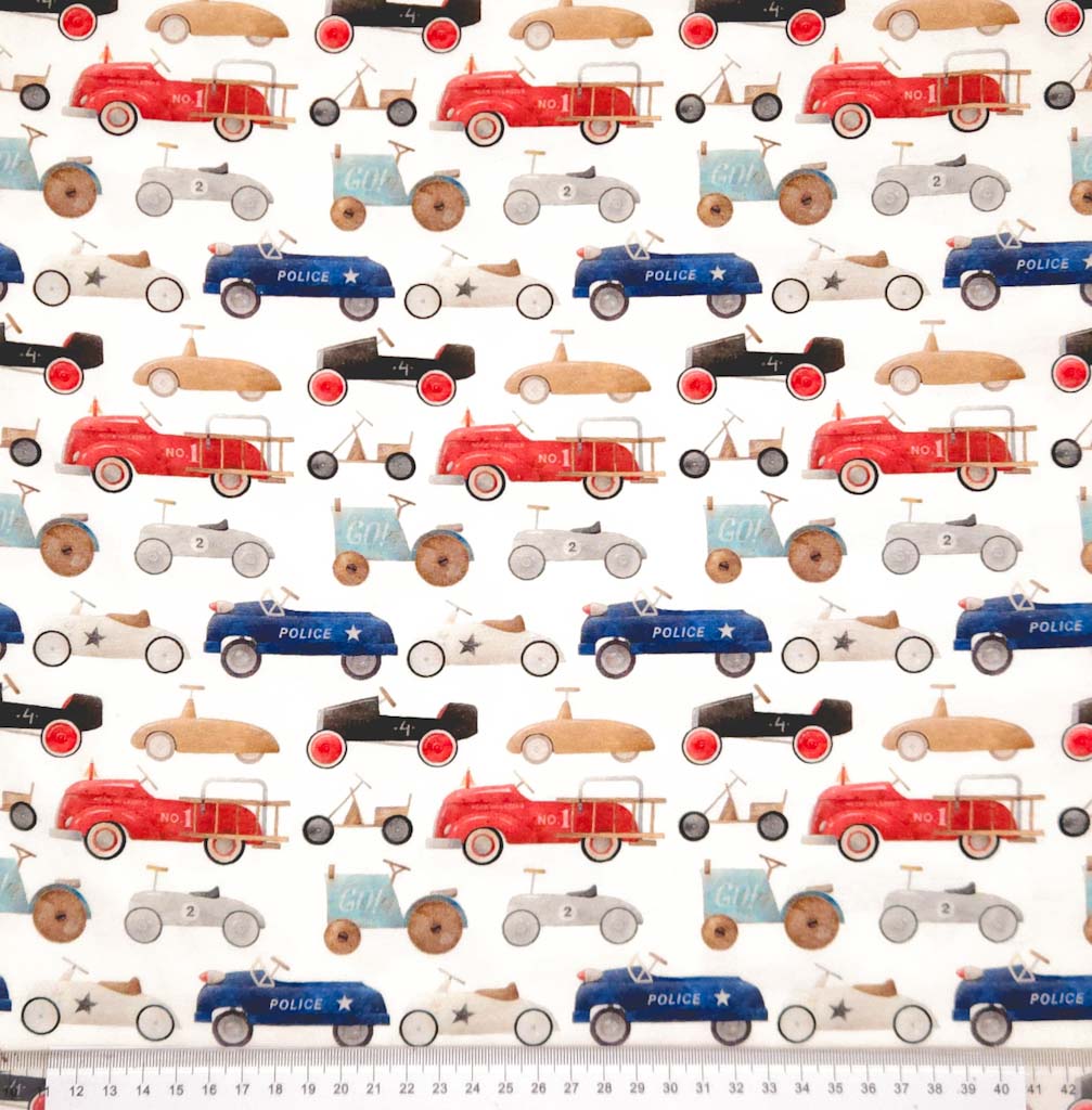 Vintage racing cars printed on a cotton jersey fabric with a cm ruler