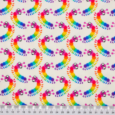 Brightly coloured caterpillars printed on an ivory cotton jersey fabric with a cm ruler