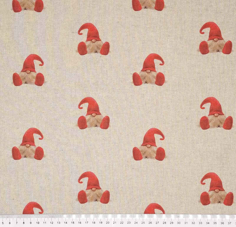 Little gonks in red hats are printed on a panama craft fabric with a cm ruler