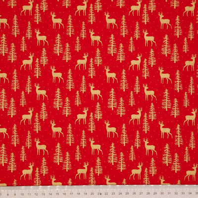 Pattern of deer and trees on a red cotton fabric