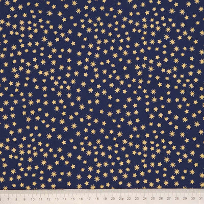 Navy blue fabric with small gold star patterns, ruler at the bottom for scale.
