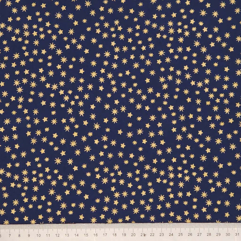 Navy blue fabric with small gold star patterns, ruler at the bottom for scale.