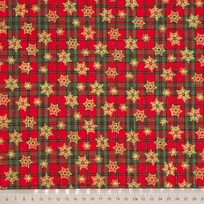 Red and green plaid fabric with gold snowflakes on a cotton fabric