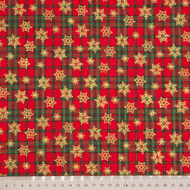 Red and green plaid fabric with gold snowflakes on a cotton fabric