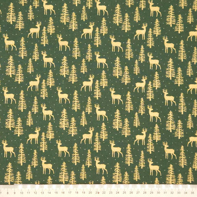 Pattern of deer and trees on a green cotton fabric