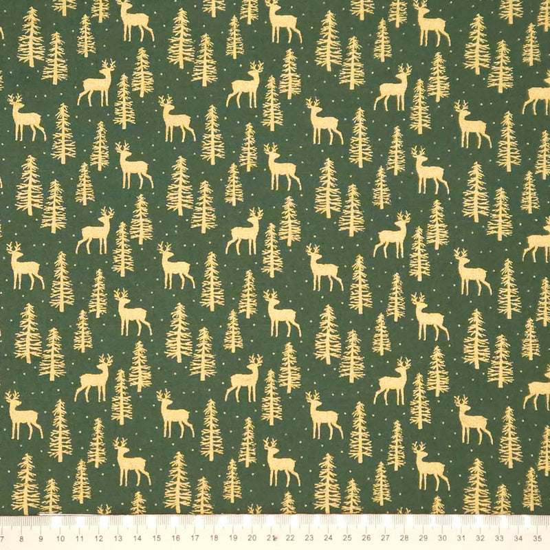 Pattern of deer and trees on a green cotton fabric