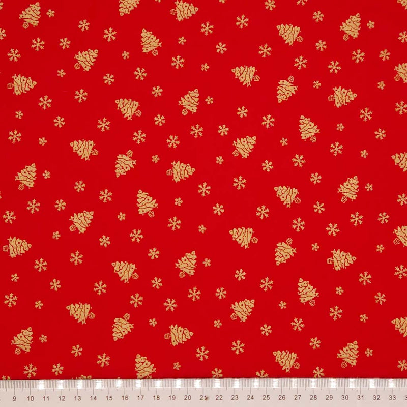 Red fabric with gold Christmas tree and snowflake pattern
