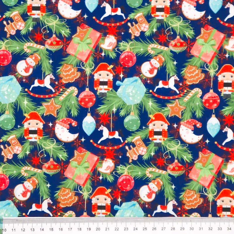 Christmas decorations printed on a navy blue polycotton fabric with a cm ruler